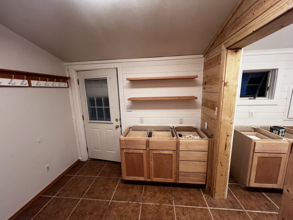 New cabinet, floating shelf, and wood paneling installation by Iron Horse Handyman Services LLC in Laramie, WY.
