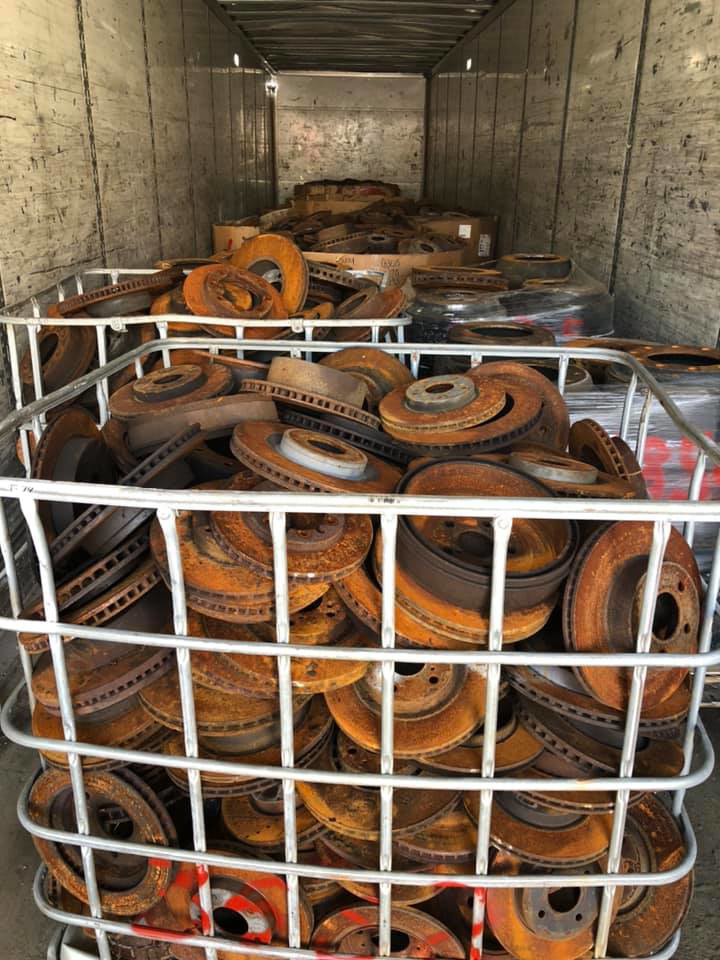 A large cage filled with rusty brake rotors inside a trailer for Metal Recycling Inc in Johnson City, TN