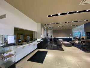 The interior of a car dealership reception and waiting area, a commercial renovation project by Spectrum Paint and Commercial Services, Inc. in Houston, TX.