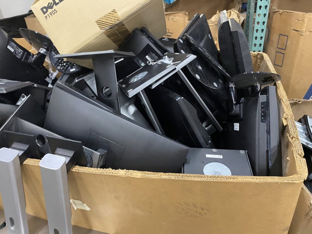 A cardboard box filled with computer monitors ready for recycling at R3Ewaste in Phoenix, AZ