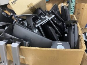 A cardboard box filled with computer monitors ready for recycling at R3Ewaste in Phoenix, AZ