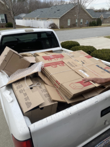 A pickup truck bed filled with cardboard boxes ready for removal by Junk Crushers in Roseville, CA.