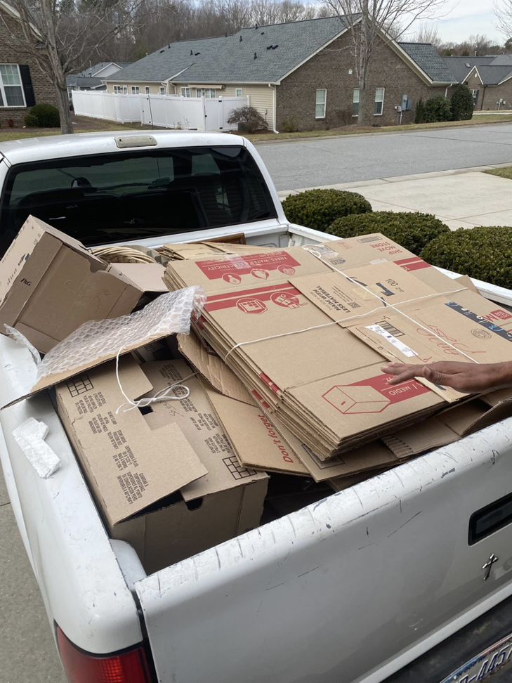 A pickup truck bed filled with cardboard boxes ready for removal by Junk Crushers in Roseville, CA.
