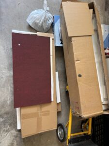 Cardboard boxes and other debris on a concrete floor, ready for removal by Junk Hawgs Removal and Rentals in Russellville, AR.