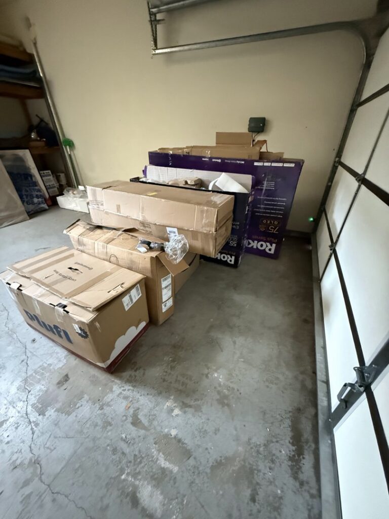A stack of cardboard boxes and packaging in a garage, ready for junk removal by West LA Hauling in Los Angeles, CA.