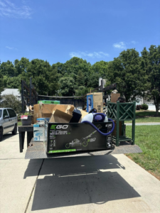 A truck loaded with cardboard boxes and a lawnmower for junk hauling by Allen's Junk Removal & Hauling in Smyrna, TN.