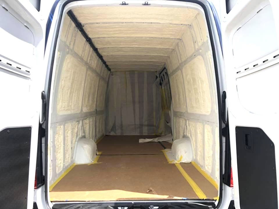 The interior of a cargo van with spray foam insulation applied to the walls and ceiling by Spray Foam Art-Insulation in Stamford, CT.