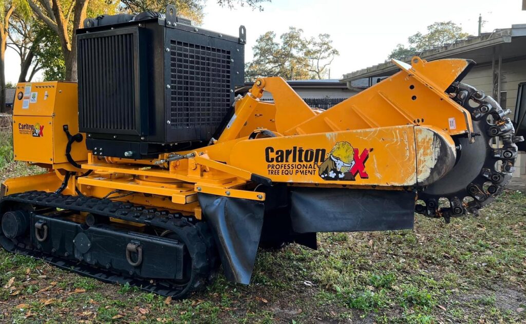 A yellow Carlton professional stump grinder, equipment used by Trinity Tree Service in Cumming, GA.