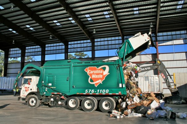 A Carolina Waste truck dumping a large load of junk and debris at a transfer station in Charleston, SC.