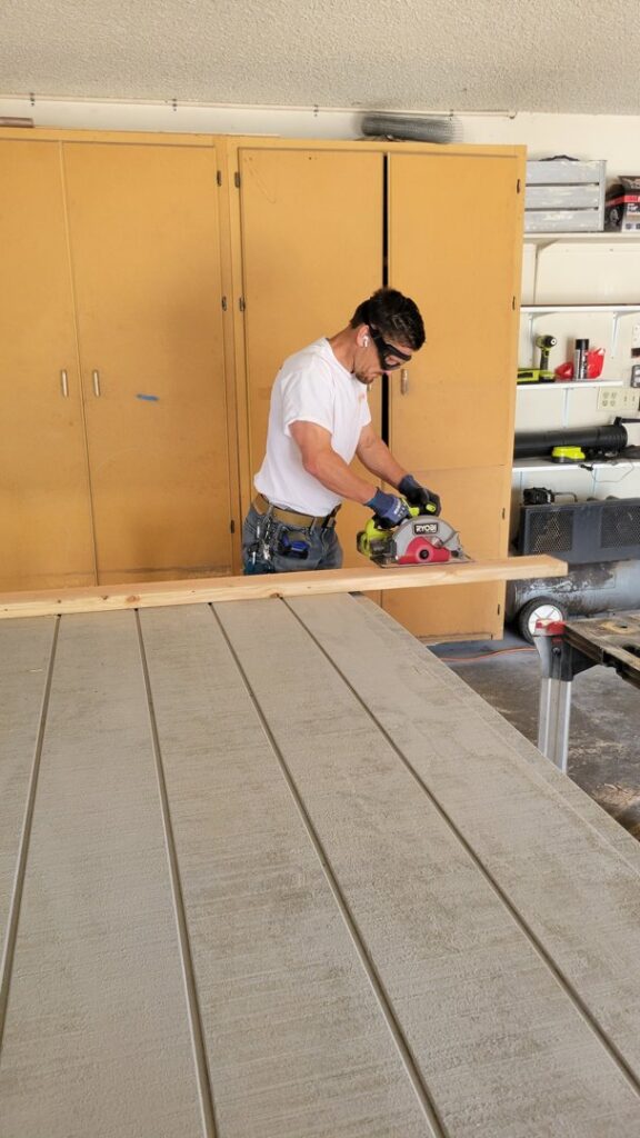 A carpenter cutting a wooden board with a circular saw for a project by My Quality Handyman in Fresno, CA.