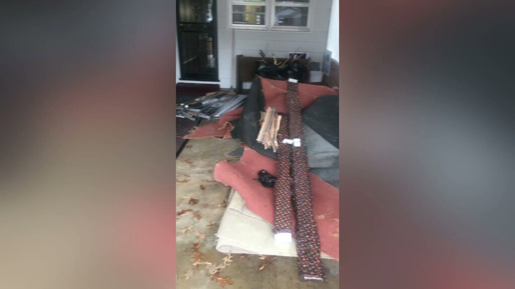 A pile of rolled carpets and other debris on a residential porch, ready for pickup by MOAT's Junk Removal LLC in Jonesboro, AR.