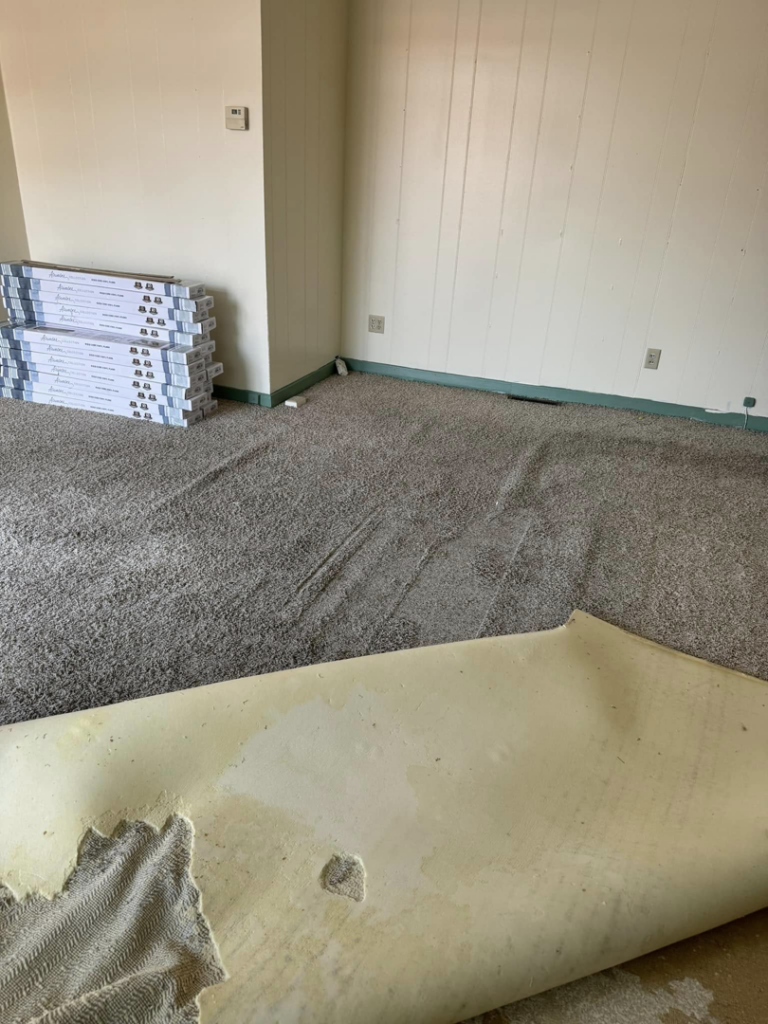 Old carpet being removed from a room, preparing for new flooring installation by Wheeler's Handyman Services in Vermillion, SD
