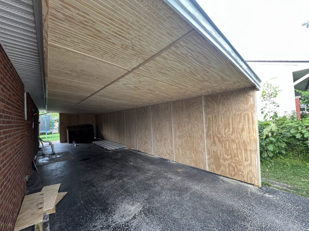 Carport with new plywood siding and ceiling panels installed by Jarrett's Home Improvements & Maintenance Services in Columbus, OH