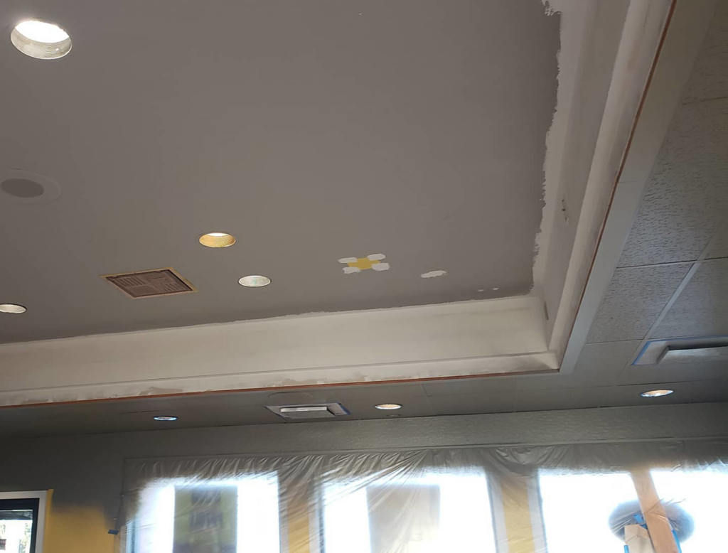 A renovated ceiling with recessed lighting and walls prepped for painting during an interior project by RG Construction WA, LLC in Portland, OR.