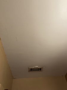 Ceiling with minor imperfections around an air vent, ready for drywall repair by S & H Painting and Drywall LLC in Montgomery, AL.