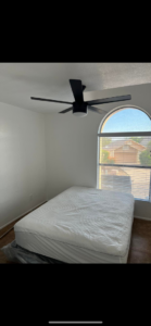 A newly installed black ceiling fan in a freshly painted bedroom by Arizona Contracting And Remodeling LLC in Tucson, AZ