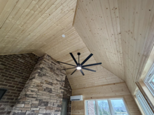 A large black ceiling fan installed in a room with a beautiful wooden vaulted ceiling by JM Home and Property Services in Clarksville, TN