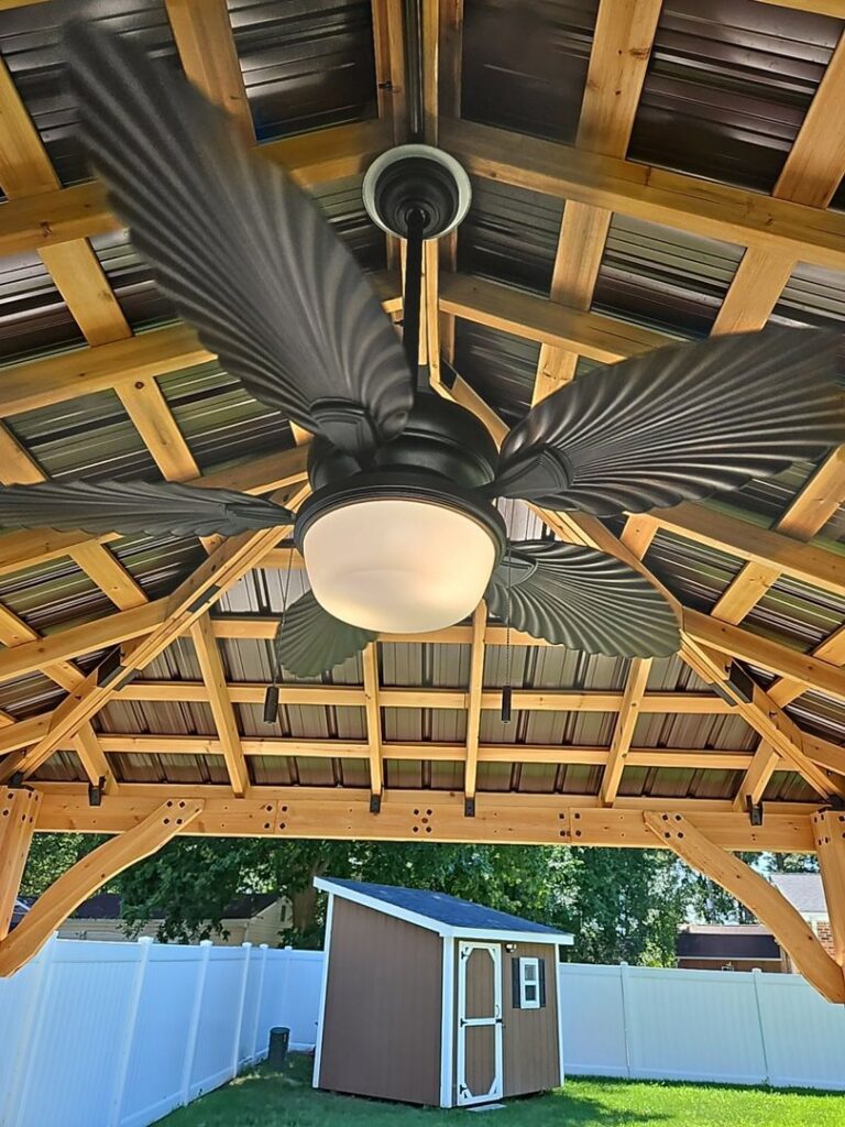 A newly installed ceiling fan with lights under a wooden gazebo roof by MorLite Electric in Newport News, VA.