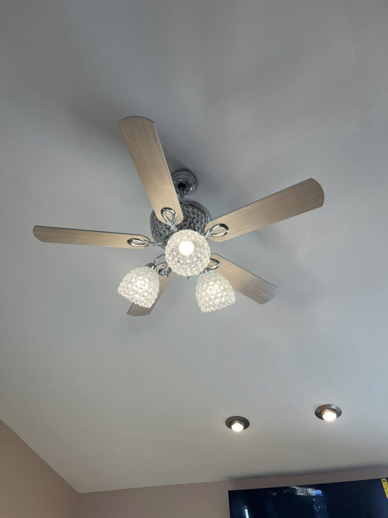 A ceiling fan with crystal light fixtures and recessed lighting installed by GOAT Tv Mounting & Home Improvement L.L.C in Toledo, OH.