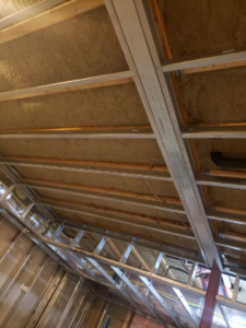 Ceiling framing and insulation installation in progress by Rizzo Renovations in Saint James, NY.