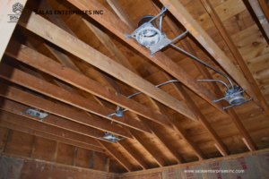 Exposed ceiling framing with new recessed lighting fixtures being installed by Salas Enterprises, Inc in Elgin, IL