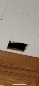 A rectangular hole cut into a textured ceiling, indicating drywall or access repair by Katzenstein llc handyman in Council Bluffs, IA.