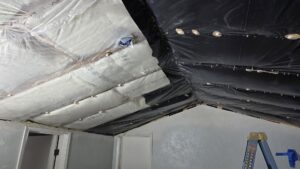 Ceiling insulation and black vapor barrier being installed, a service by Infinity Handyman in Anchorage, AK