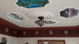 A ceiling with a decorative medallion and chandelier installation by Borrelli Plastering & Sons in O'Fallon, MO.