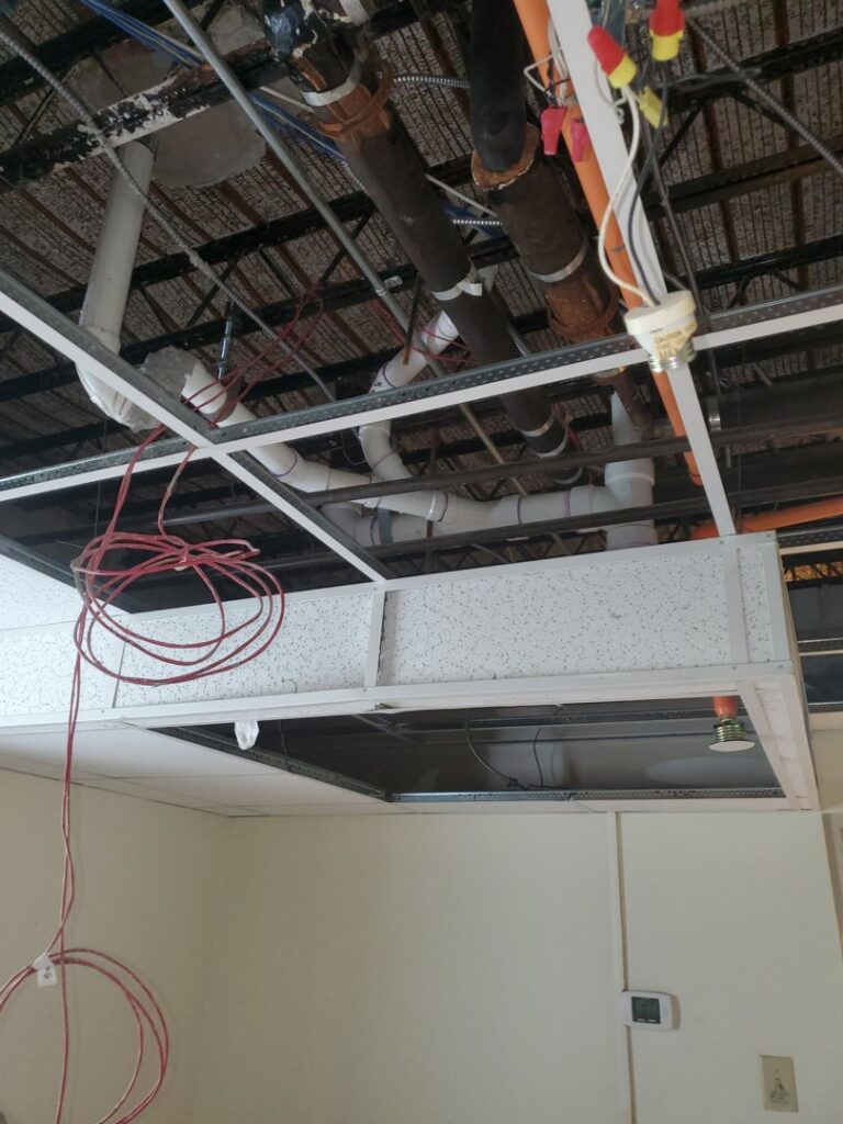 Exposed plumbing, electrical, and HVAC components in a ceiling during installation by Snyder Solutions LLC in Richmond, VA