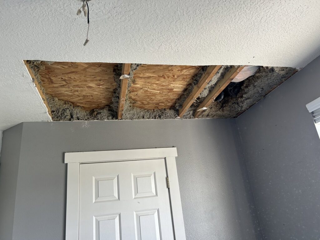 Ceiling repair work in progress, showing exposed insulation, by Rockin & Rollin Handyman Services in North Ogden, UT.