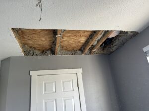 Ceiling repair work in progress, showing exposed insulation, by Rockin & Rollin Handyman Services in North Ogden, UT.