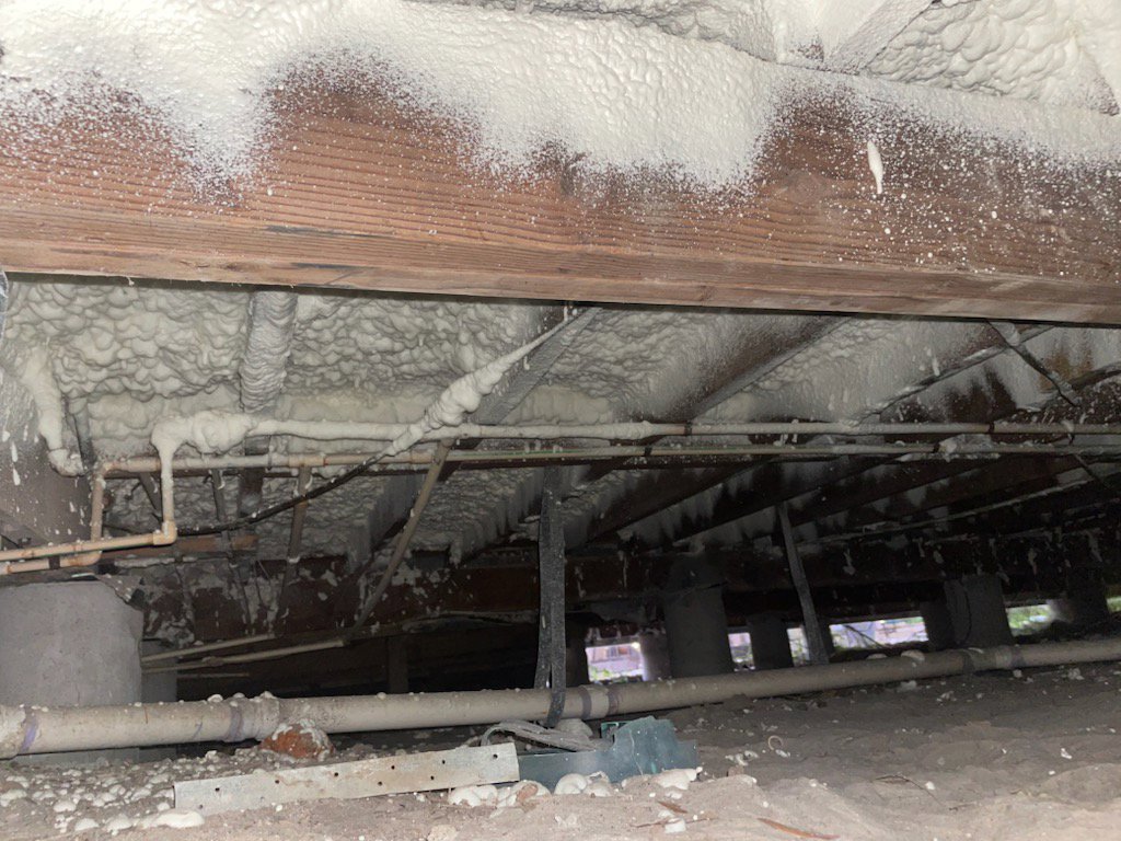 Spray foam insulation applied between ceiling joists during a construction project by Absolute Pro Insulation in Corpus Christi, TX.
