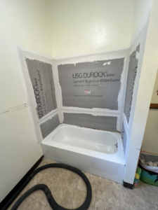 Cement board installed around a new bathtub, preparing for shower tile installation by JKM Services in Solon, OH.