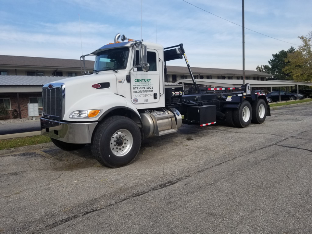 A white Century Waste Management roll-off truck parked in Sterling Heights, MI, ready for junk removal services.