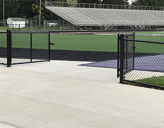 Black chain link fence gates installed at a sports facility by R & C Fence in Fort Wayne, IN.