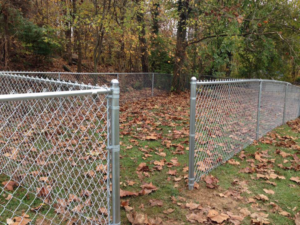A newly installed chain-link fence in a residential backyard by Fence & More in Elizabethtown, KY