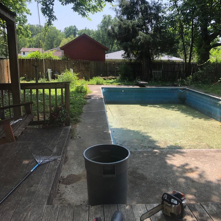 A chainsaw on the ground, ready for tree service work by Benigno Perez Tree Services in Louisville, KY.