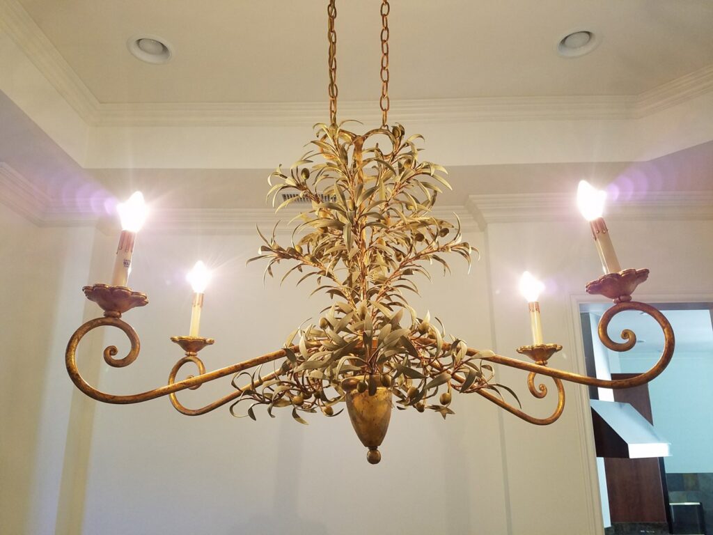 An elegant chandelier with decorative leaves and multiple lights installed by Barry's Handyman Service in San Diego, CA.