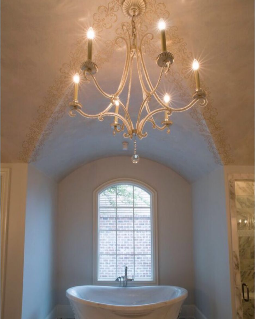 A beautifully installed chandelier in a bathroom by Bernhard Normand Construction in Baton Rouge, LA.