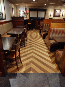 Chevron pattern wood-look flooring installed in a restaurant by Flooring of Keystone in Keystone Heights, FL