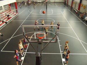 Children playing basketball on a newly installed indoor court, a project by Abacus Sports Installations, Ltd in Lancaster, PA.