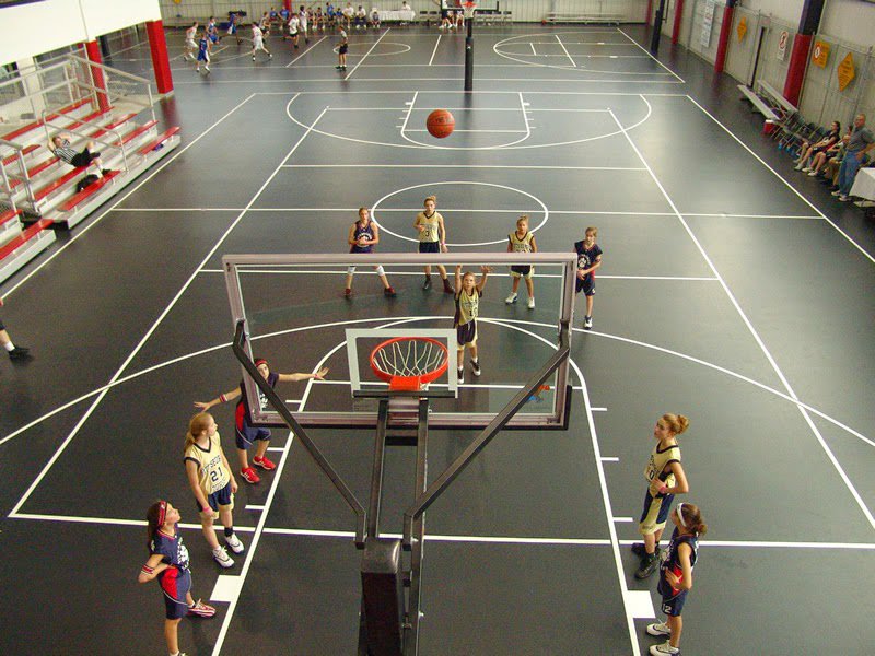 Children playing basketball on a newly installed indoor court, a project by Abacus Sports Installations, Ltd in Lancaster, PA.