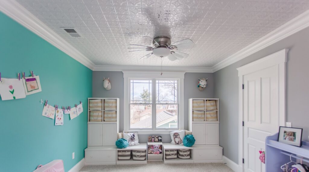 A child's bedroom featuring a newly installed ceiling fan and practical built-in storage, completed by Legacy Builders Group in Cincinnati, OH.