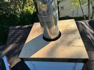 Chimney flue installation with plywood framing on a roof by Universal Builders LLC in New Haven, CT.
