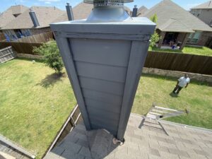 Close-up of a chimney on a roof, possibly for inspection or repair by Canek Construction LLC in Fort Worth, TX