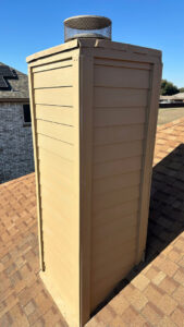 A newly installed or repaired chimney on a residential roof by Elite Handyman & Remodeling in Dallas, TX.