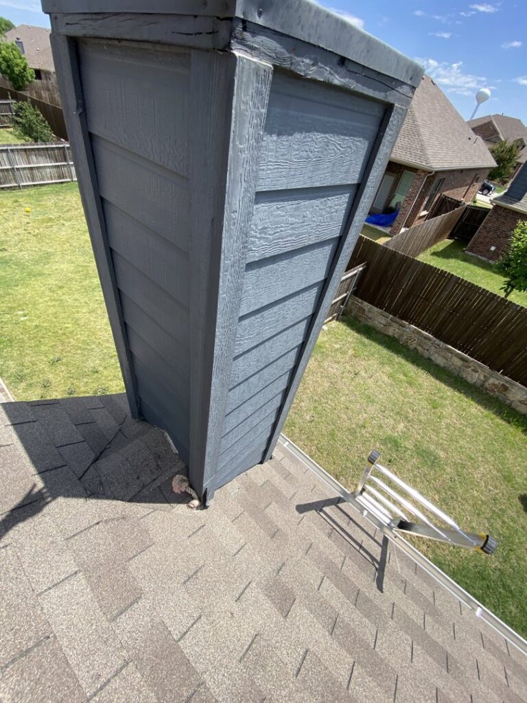 Close-up of a chimney on a roof, indicating repair or maintenance service by Canek Construction LLC in Fort Worth, TX