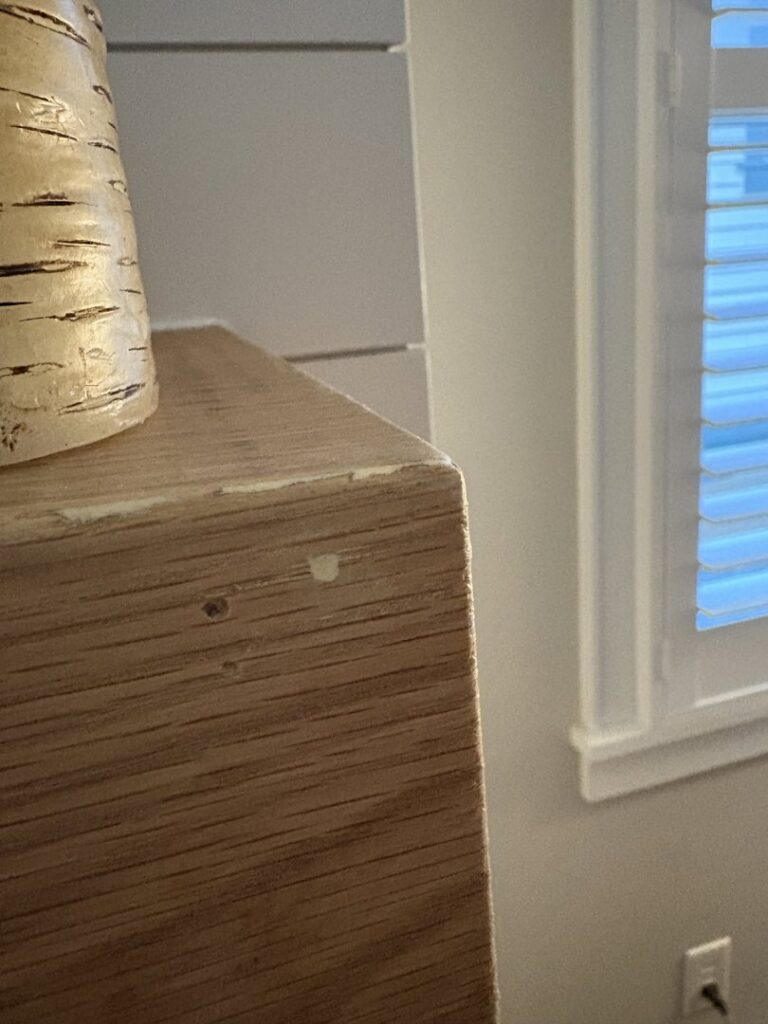 A close-up view of a chipped wooden surface requiring repair by Special Reserve Contracting in Charlotte, NC.