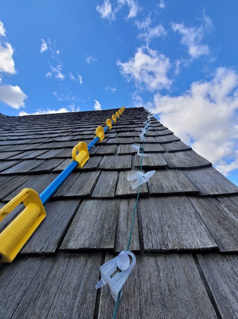 Close-up of Christmas light clips and installation tools on a roofline by Chicago Christmas Lights LLC in Chicago, IL.
