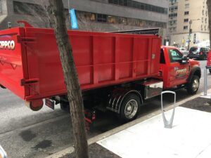 Rear and side view of a Cippco Inc. red dump truck, showcasing equipment for general contracting in Philadelphia, PA.